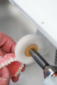 polishing dentures at premier dentures